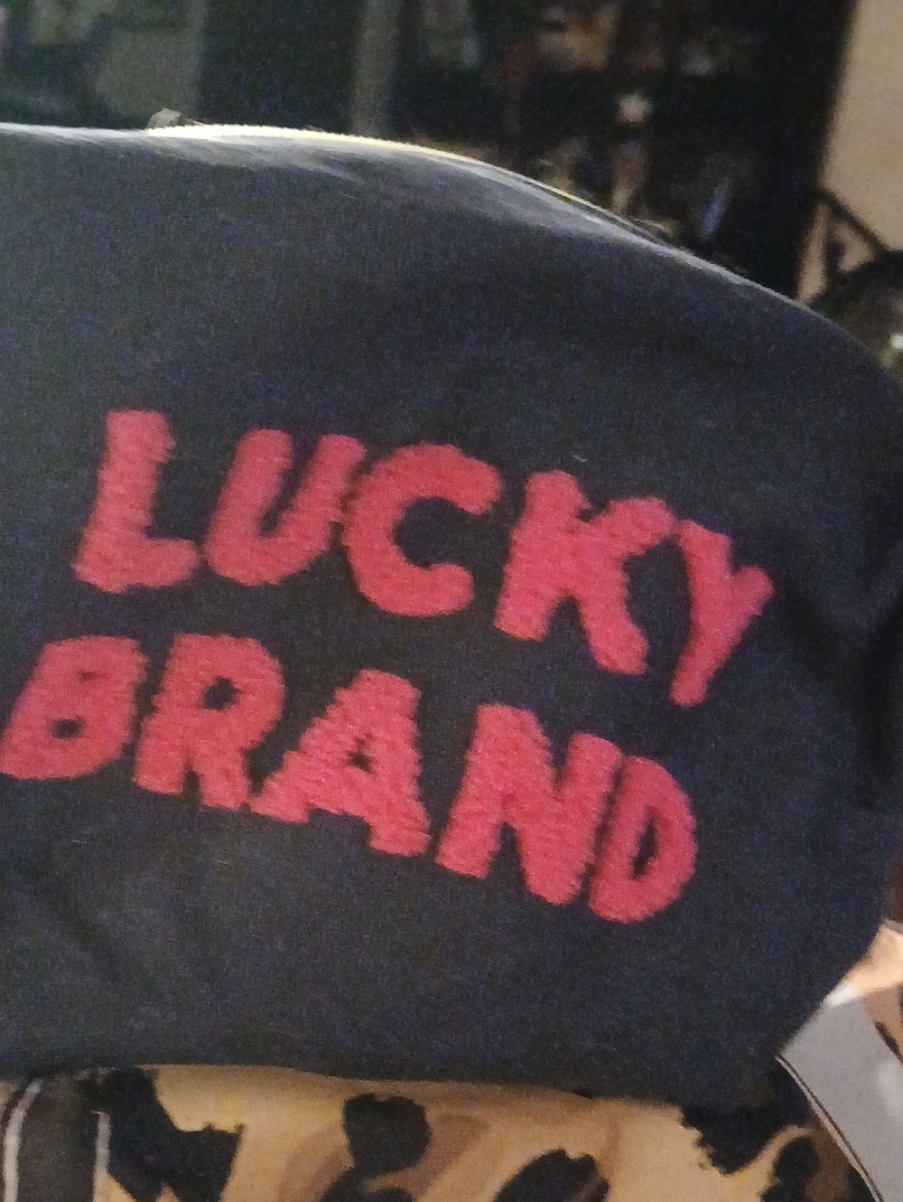 Lucky Brand Black Pouch with Red Logo Text & Bottle